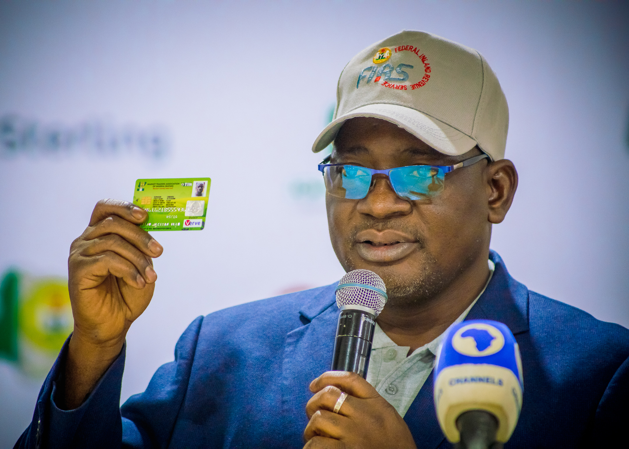 Executive Chairman, FIRS, Muhammad Nami, unveils MATAN identity card at the stakeholder engagement meeting with Market Traders Association of Nigeria (MATAN) in Lagos. 21st June 2023.